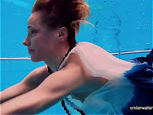 teen dame Avenna is swimming in the pool